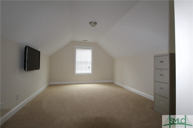 bonus room featuring lofted ceiling and light colored carpet