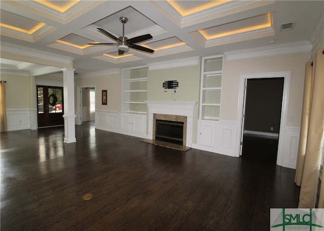 unfurnished living room with beamed ceiling, coffered ceiling, built in shelves, ceiling fan, and dark hardwood / wood-style floors