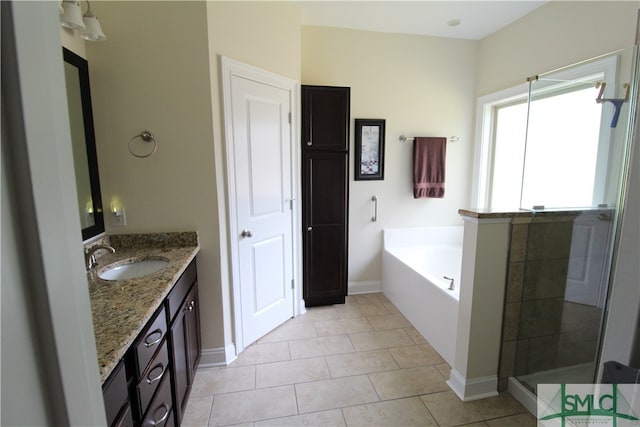 bathroom featuring tile patterned flooring, vanity, and separate shower and tub