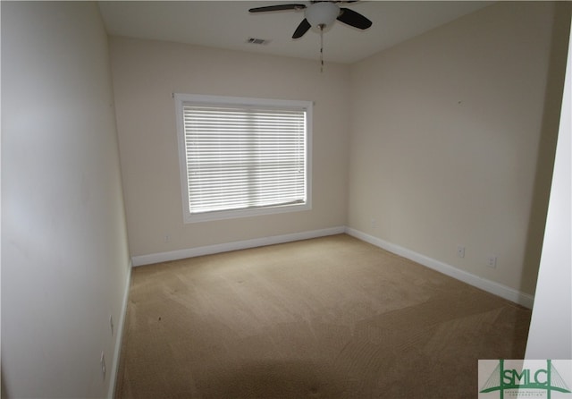 unfurnished room featuring ceiling fan and carpet floors