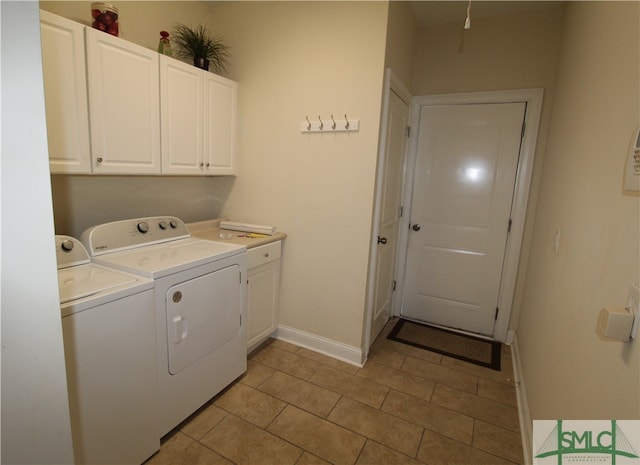 clothes washing area featuring cabinets, independent washer and dryer, and light tile patterned floors