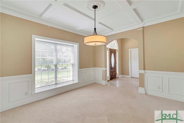 carpeted empty room with crown molding and coffered ceiling