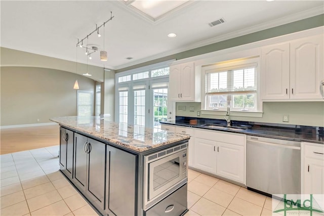 kitchen featuring sink, white cabinets, stainless steel appliances, and ornamental molding