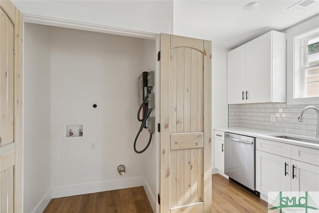 laundry room with washer hookup, hookup for an electric dryer, light hardwood / wood-style floors, and sink