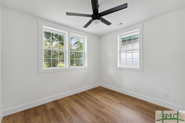 spare room with ceiling fan and hardwood / wood-style floors