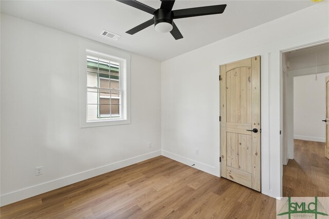 unfurnished bedroom featuring ceiling fan, a closet, and light hardwood / wood-style floors