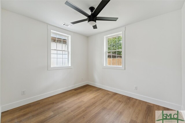 empty room featuring hardwood / wood-style floors and ceiling fan