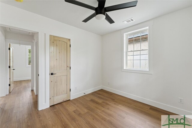 unfurnished bedroom with ceiling fan and light wood-type flooring