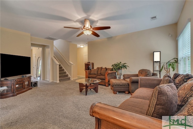 living room featuring carpet and ceiling fan