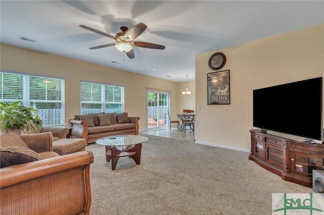 carpeted living room featuring ceiling fan