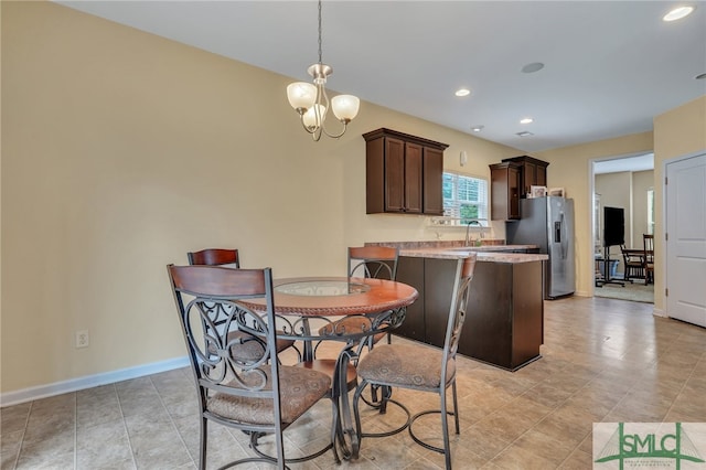 dining area with an inviting chandelier and sink