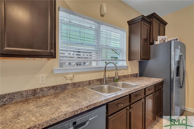 kitchen with stainless steel refrigerator with ice dispenser, dark brown cabinets, and sink