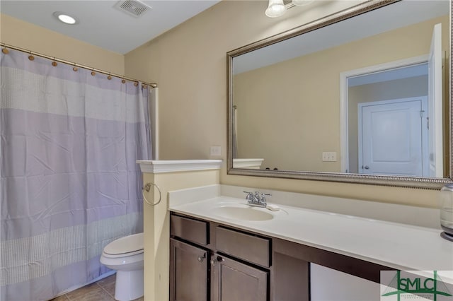 bathroom with vanity, toilet, walk in shower, and tile patterned floors