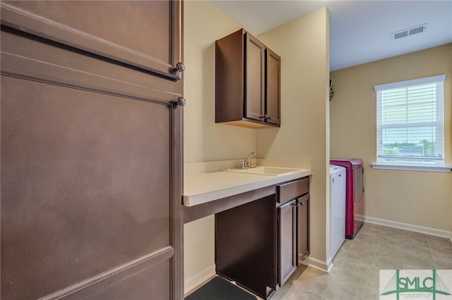 bathroom with tile patterned flooring, independent washer and dryer, and vanity