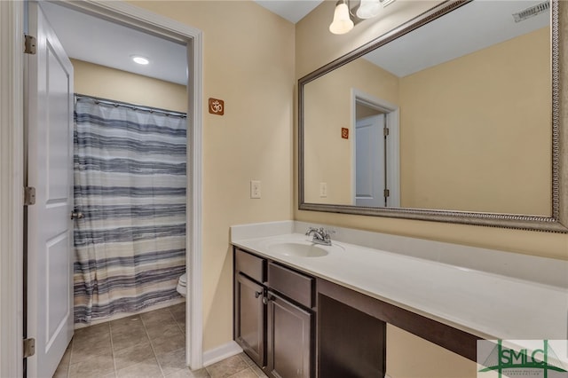 bathroom with vanity, toilet, a shower with shower curtain, and tile patterned flooring