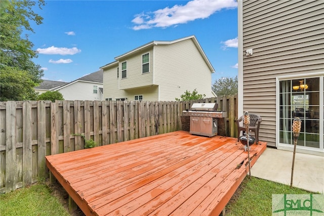 deck with a patio and area for grilling