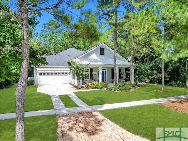 view of front of house with a garage, a front yard, and a porch