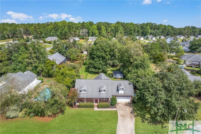 birds eye view of property featuring a wooded view