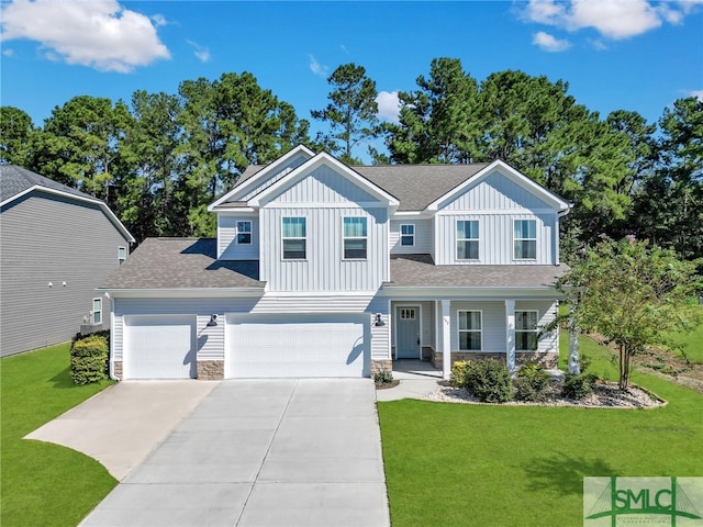 view of front of property featuring covered porch, a front yard, and a garage