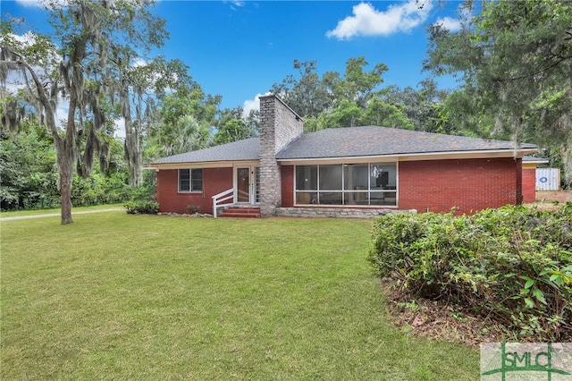 rear view of house with a lawn