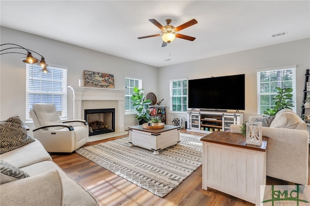 living room featuring hardwood / wood-style flooring and ceiling fan