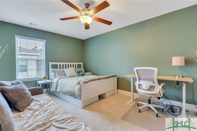 bedroom featuring light colored carpet and ceiling fan