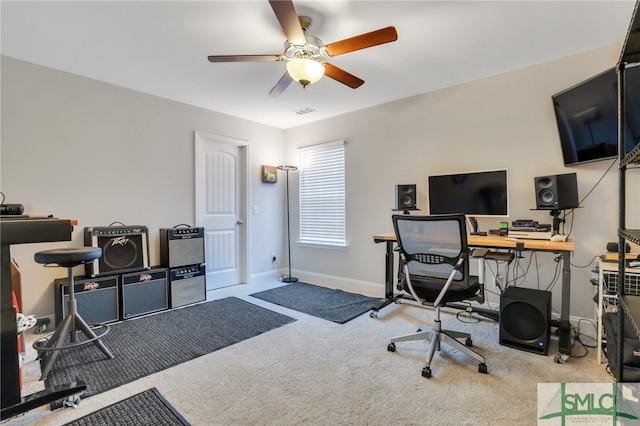 carpeted home office with ceiling fan