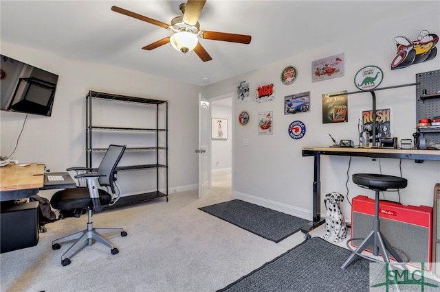 carpeted office space featuring ceiling fan