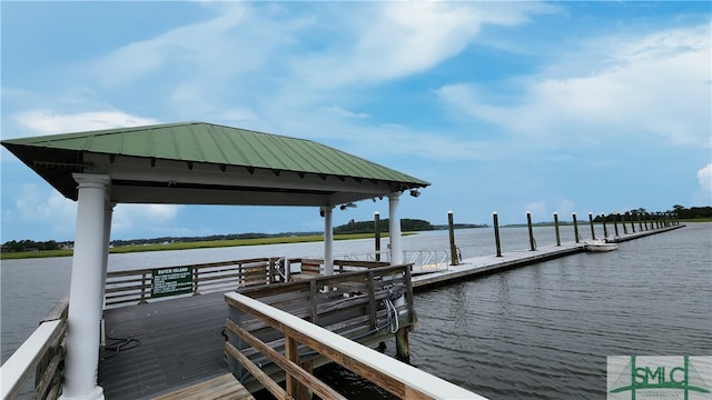 view of dock with a gazebo and a water view