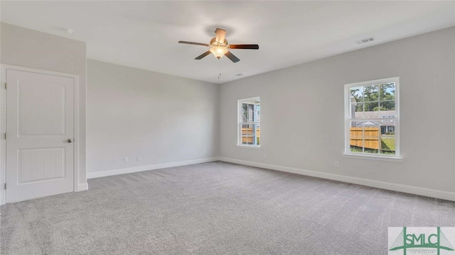 carpeted spare room with ceiling fan