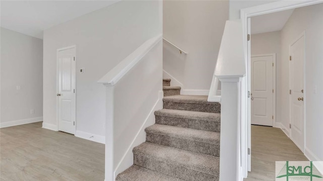 stairs with hardwood / wood-style flooring