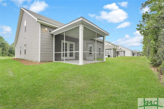 rear view of property with a yard and a patio area