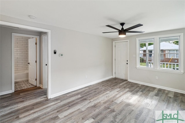 spare room featuring wood-type flooring and ceiling fan