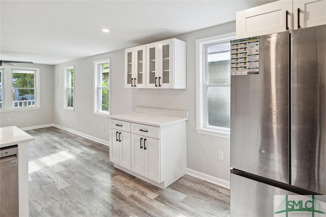 kitchen featuring white cabinetry, plenty of natural light, and stainless steel appliances