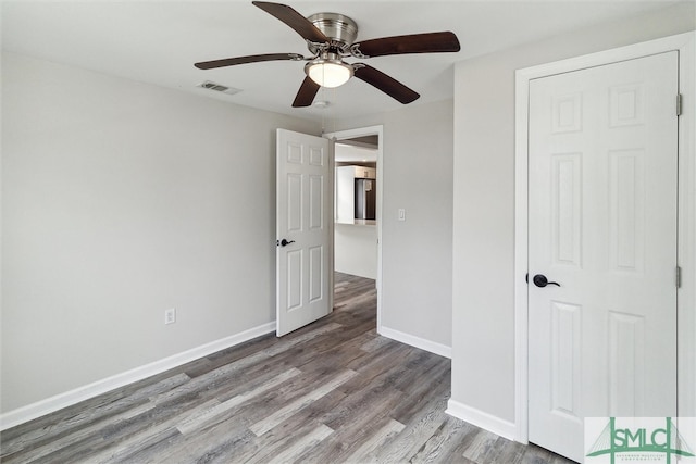 unfurnished bedroom with hardwood / wood-style floors and ceiling fan