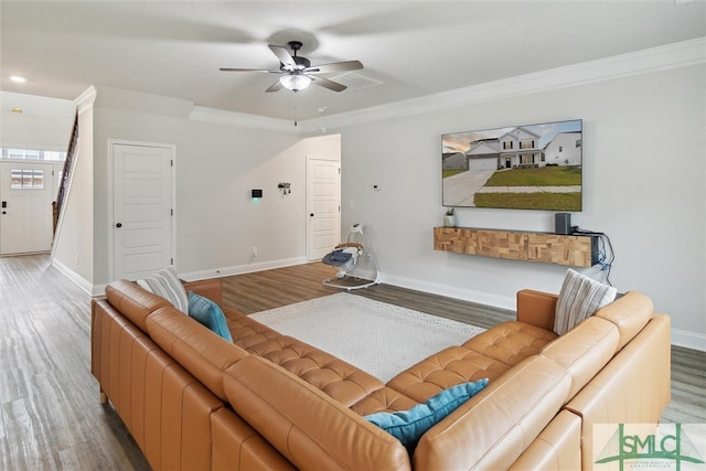 living room featuring wood-type flooring, ornamental molding, and ceiling fan