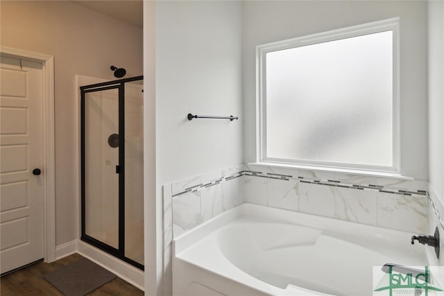 bathroom featuring shower with separate bathtub and wood-type flooring