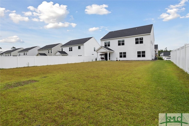 rear view of house with a lawn