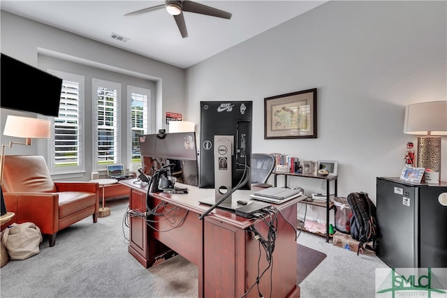 carpeted home office with ceiling fan