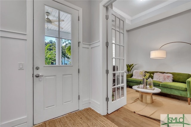 entryway featuring crown molding and hardwood / wood-style floors