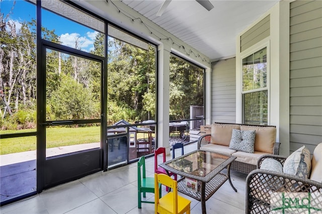 sunroom / solarium featuring ceiling fan