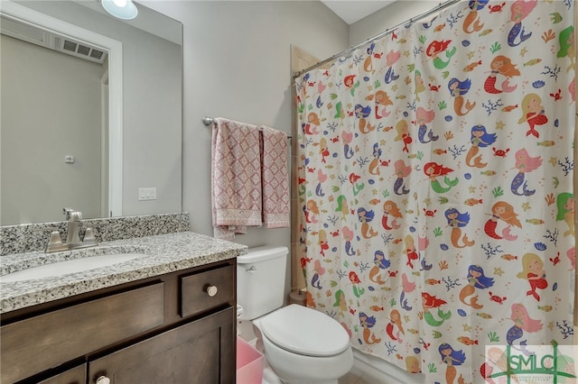 bathroom featuring vanity and toilet