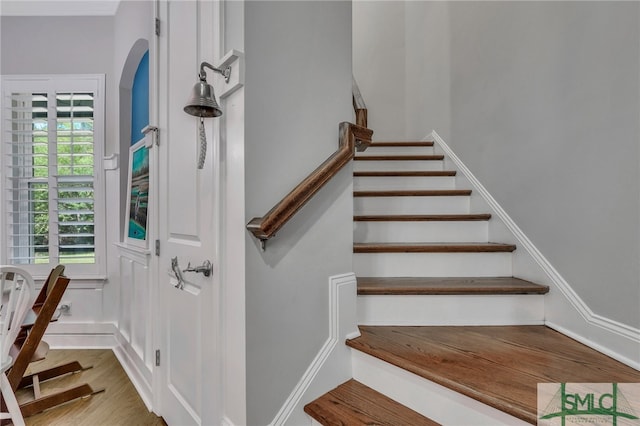 stairs featuring hardwood / wood-style floors