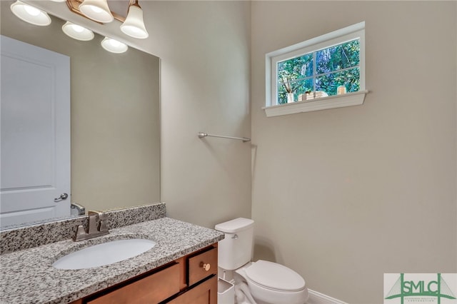 bathroom with toilet and vanity