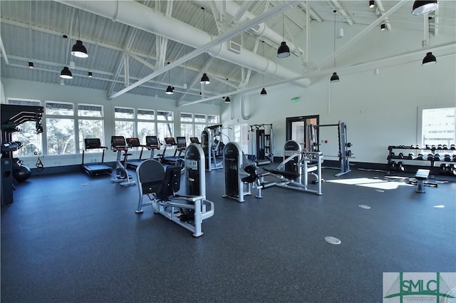 workout area featuring high vaulted ceiling