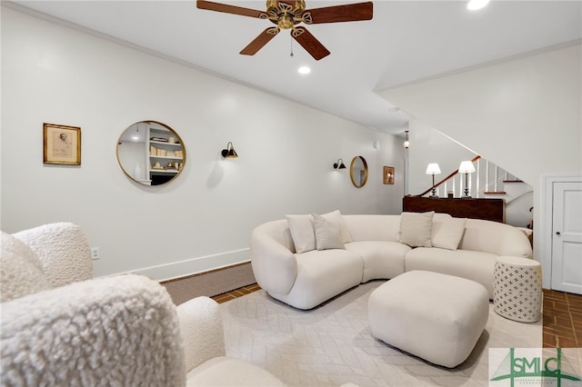 living room featuring ceiling fan and ornamental molding