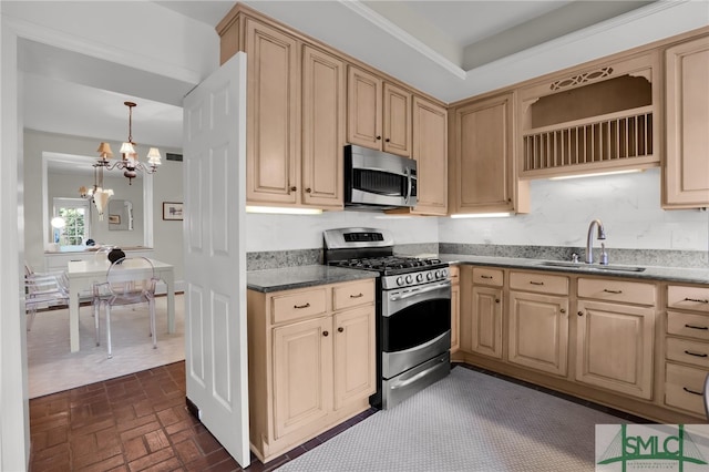 kitchen featuring light brown cabinets, sink, decorative light fixtures, appliances with stainless steel finishes, and a notable chandelier