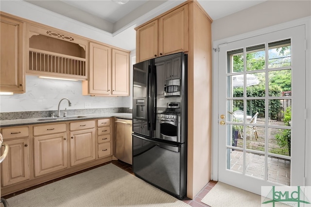 kitchen featuring tasteful backsplash, light brown cabinetry, stainless steel appliances, and sink