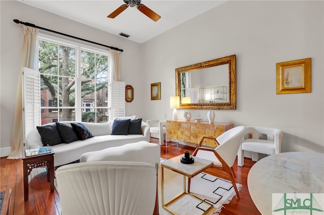 living room with dark hardwood / wood-style floors and ceiling fan