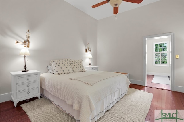 bedroom featuring ceiling fan and dark wood-type flooring